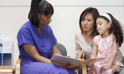 Nurse-talking-to-mother-and-daughter-696x464