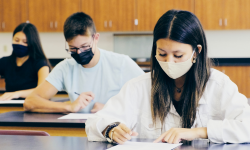 Students wearing masks while taking an exam in a classroom